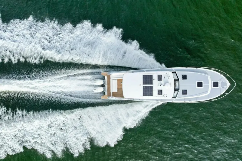 Slide: The Image of Aerial view of 2025 MJM 42 yacht cruising on green water. - 45