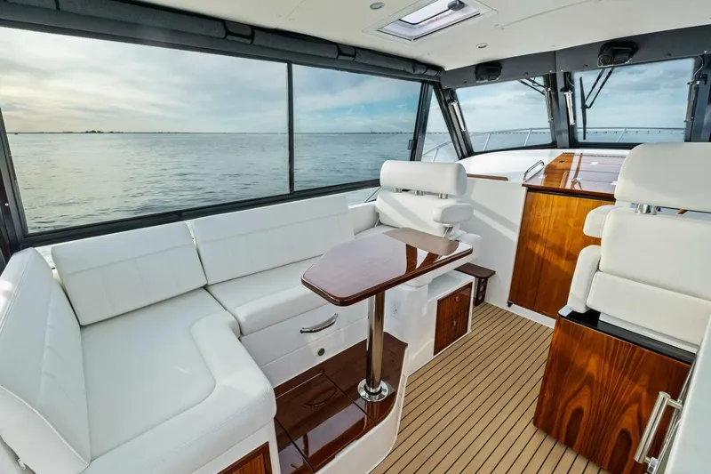 Slide: The Image of Luxurious interior of 2025 MJM 42 yacht with white seating and wooden accents. - 9