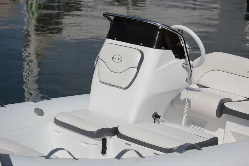 Slide: The Image of Manufacturer Provided Image: 2025 Walker Bay Venture 14 boat interior with sleek white seating and modern console design. - 10