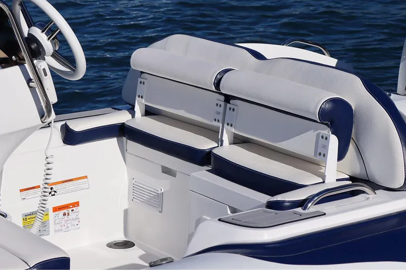 Slide: The Image of Manufacturer Provided Image: 2025 Walker Bay Venture 16 boat interior with cushioned seating and steering wheel. - 11