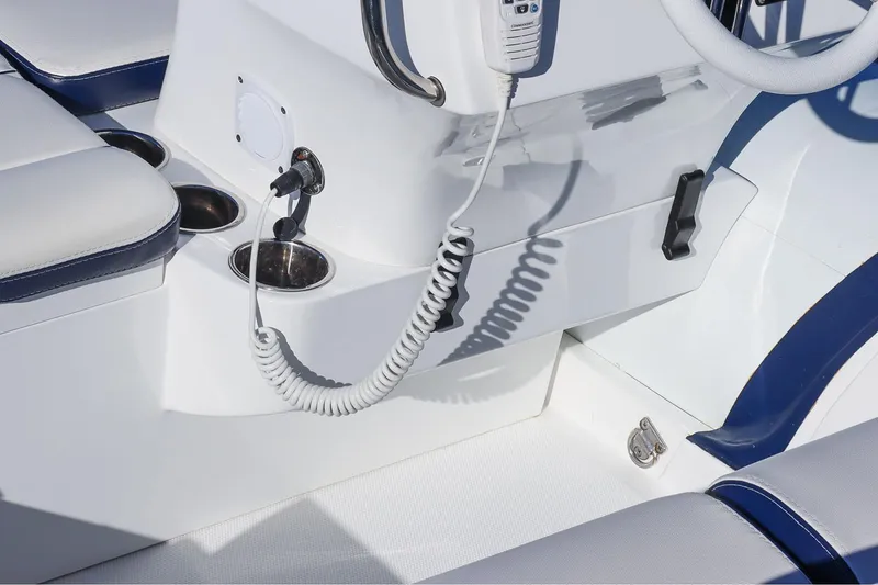 Slide: The Image of Manufacturer Provided Image: Walker Bay Venture 16 boat interior, 2025 model, featuring cup holders and control panel. - 12