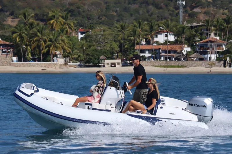 Slide: The Image of Manufacturer Provided Image: Walker Bay Venture 16 boat cruising on water, 2025 model, with passengers enjoying a sunny day. - 2