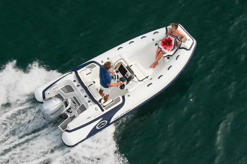 Slide: The Image of Manufacturer Provided Image: Walker Bay Venture 16 boat cruising on water, 2025 model, with two passengers onboard. - 4