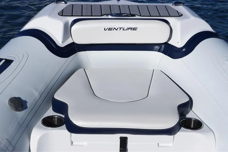 Slide: The Image of Manufacturer Provided Image: Walker Bay Venture 16 boat interior, 2025 model, featuring sleek white and navy seating. - 7