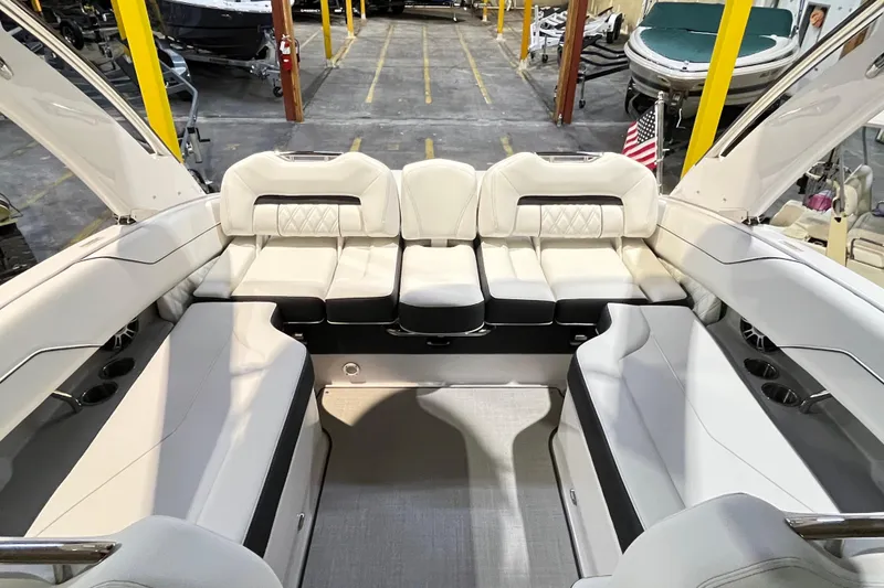 Slide: The Image of 2025 Regal LS4 boat interior with luxurious white seating in a showroom. - 4