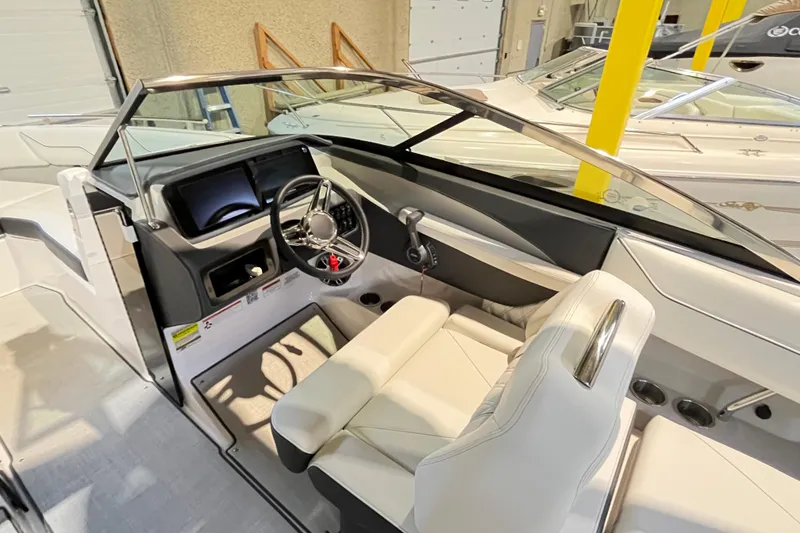 Slide: The Image of 2025 Regal LS4 boat interior with modern steering and dashboard in showroom setting. - 6