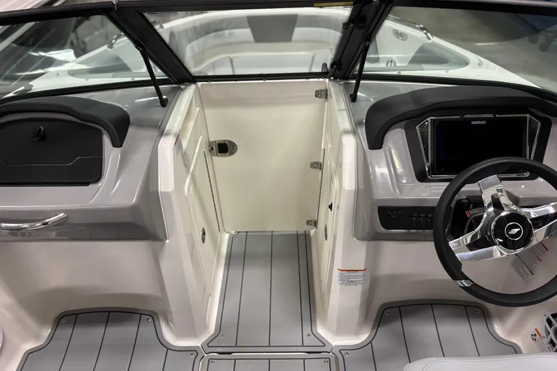 Slide: The Image of 2026 Chaparral 21 SSi OB boat interior with steering wheel and dashboard controls. - 18