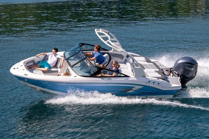 Slide: The Image of Manufacturer Provided Image: 2026 Chaparral 21 SSi OB boat cruising on a clear blue lake with passengers. - 23