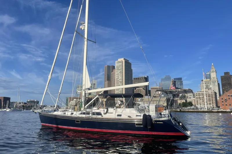 The Image of Sailboat Hylas 46 (2002) on water with city skyline background. - 0