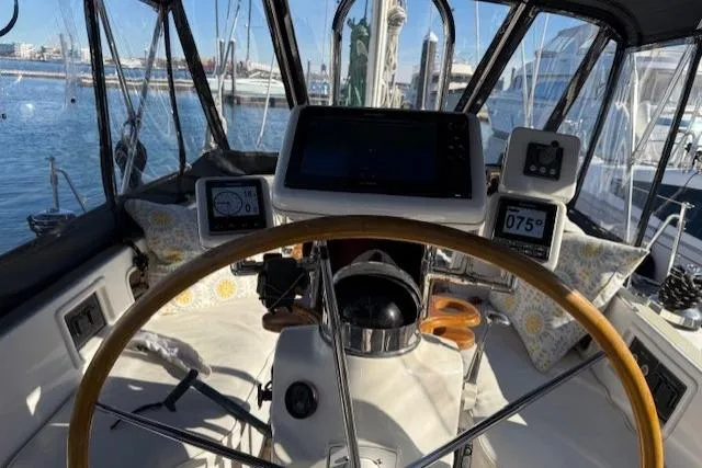 Slide: The Image of Cockpit of 2002 Hylas 46 sailboat with navigation instruments and wooden steering wheel. - 11