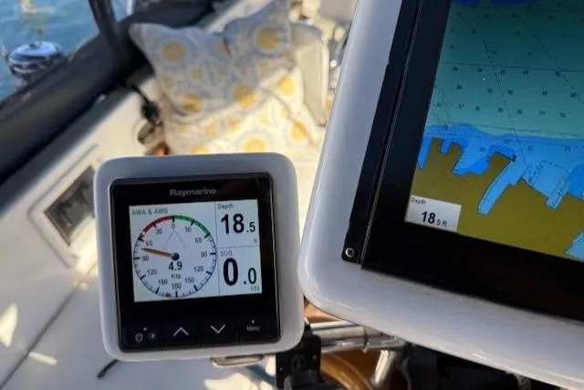 Slide: The Image of Navigation instruments on a 2002 Hylas 46 sailboat, displaying depth and map data. - 14