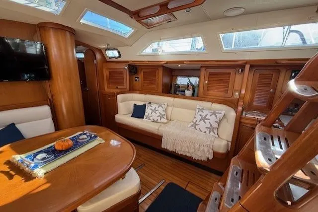 Slide: The Image of Luxurious interior of a 2002 Hylas 46 yacht with elegant wood finishes and cozy seating. - 22