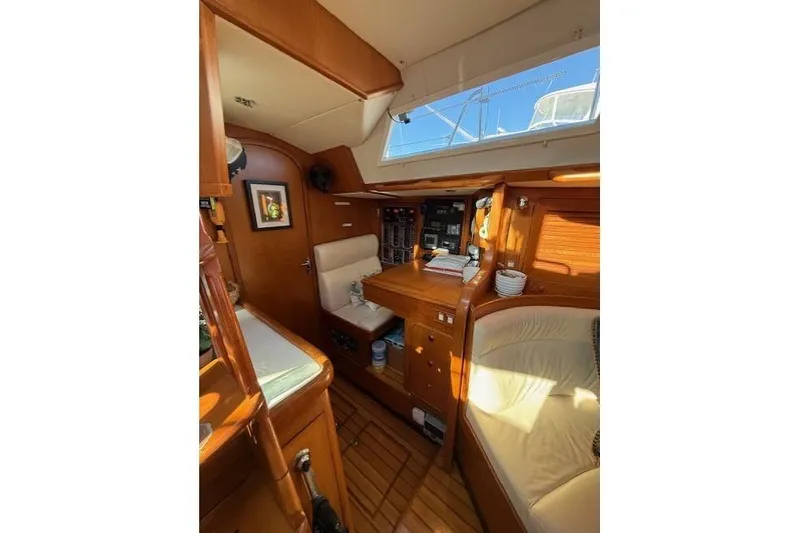 Slide: The Image of Interior of a 2002 Hylas 46 yacht with wooden furnishings and seating area. - 24