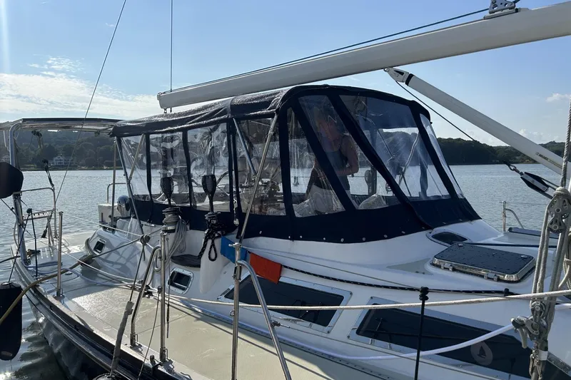 Slide: The Image of Sailing yacht Hylas 46, 2002 model, docked with protective canopy, on calm water. - 3