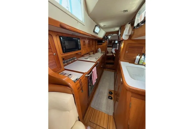 Slide: The Image of Interior of 2002 Hylas 46 yacht with wooden cabinetry and modern amenities. - 30