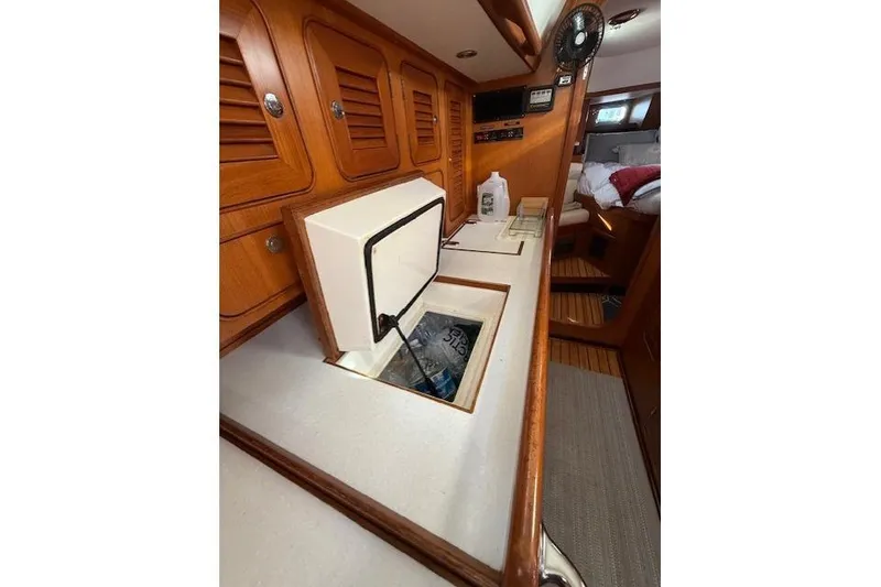Slide: The Image of Interior of 2002 Hylas 46 yacht with open storage compartment and wooden cabinetry. - 32