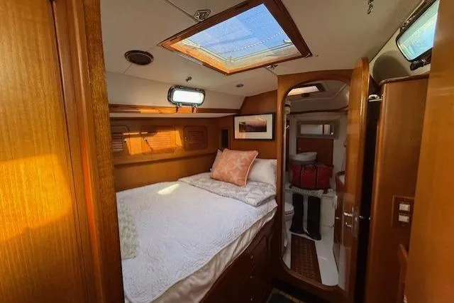 Slide: The Image of Cozy cabin interior of 2002 Hylas 46 yacht with skylight and wooden furnishings. - 33