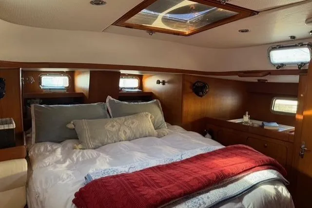 Slide: The Image of Cozy cabin interior of 2002 Hylas 46 yacht with skylight and plush bedding. - 34