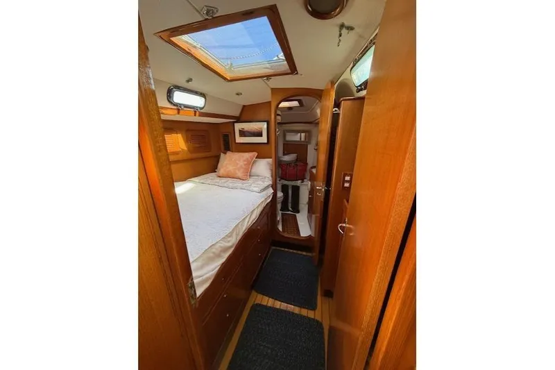 Slide: The Image of Cozy cabin interior of 2002 Hylas 46 yacht with wooden finish and skylight. - 38