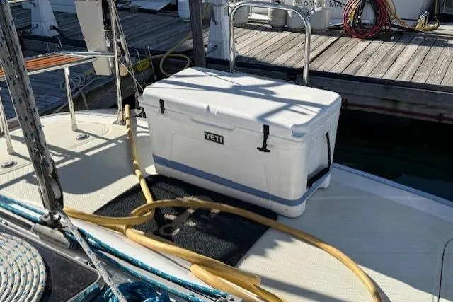 Slide: The Image of White Yeti cooler on 2002 Hylas 46 yacht deck near marina. - 42