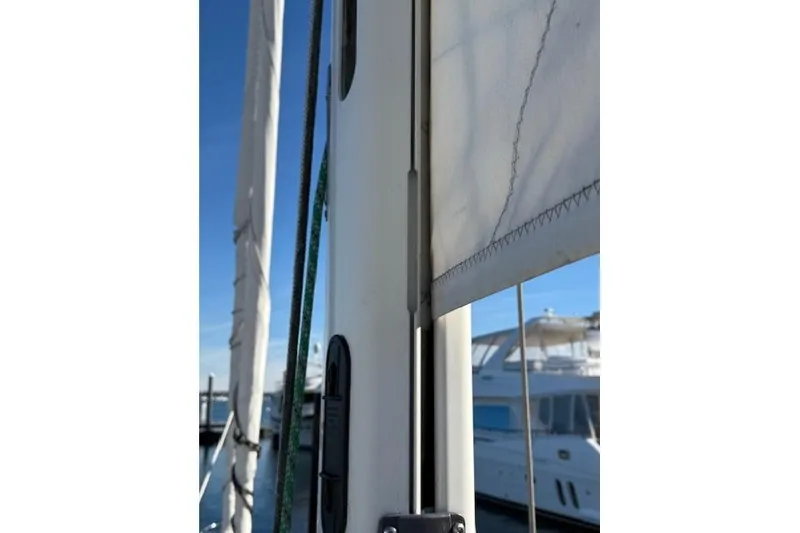 Slide: The Image of Close-up of a 2002 Hylas 46 sailboat mast and sail details at a marina. - 44