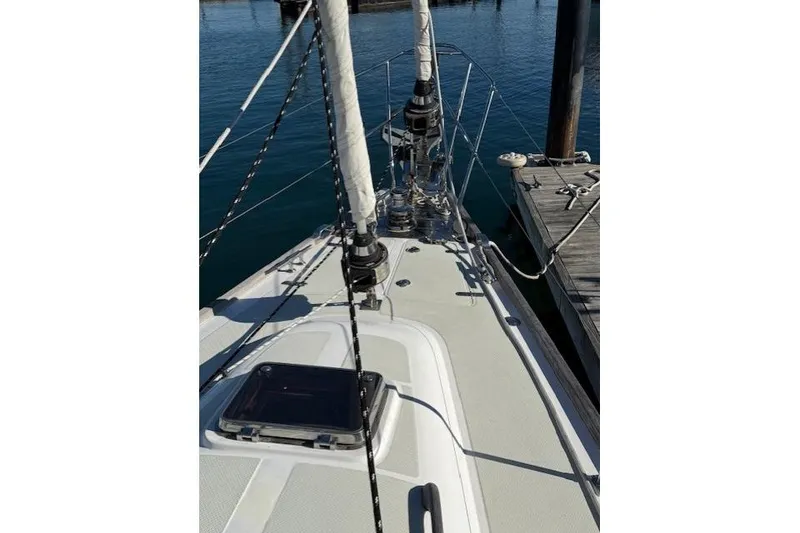 Slide: The Image of 2002 Hylas 46 sailboat deck view at marina, showcasing rigging and hatch. - 45