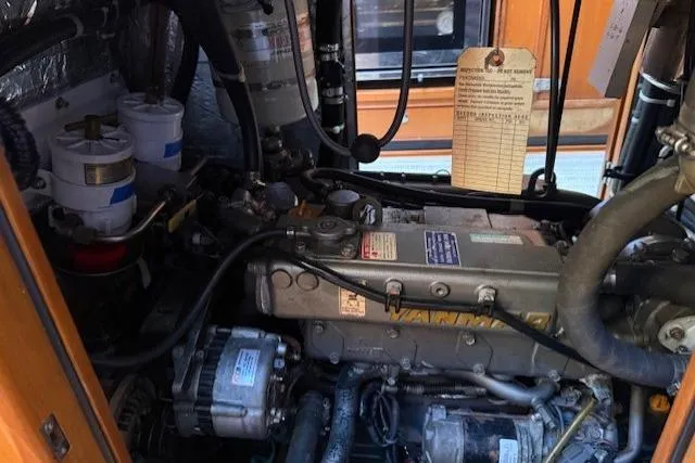 Slide: The Image of Engine compartment of a 2002 Hylas 46 yacht, featuring a Yanmar engine. - 48