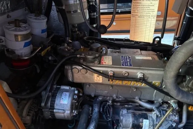 Slide: The Image of Engine compartment of a 2002 Hylas 46 yacht, featuring a Yanmar engine. - 49