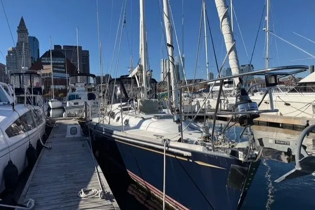 Slide: The Image of Sailboat docked in marina, Hylas 46 model, 2002, with city skyline in background. - 5