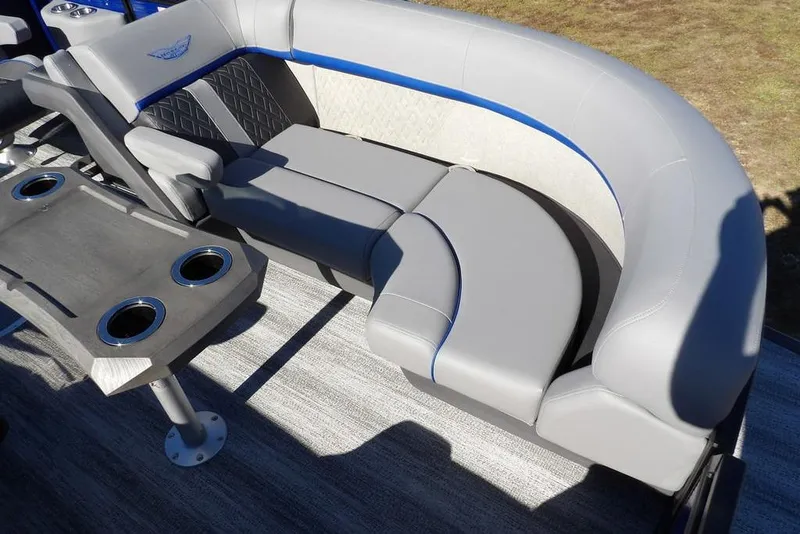 Slide: The Image of 2026 Bennington M Quad Bench 22 MFB with gray seating and cupholders on a boat. - 14