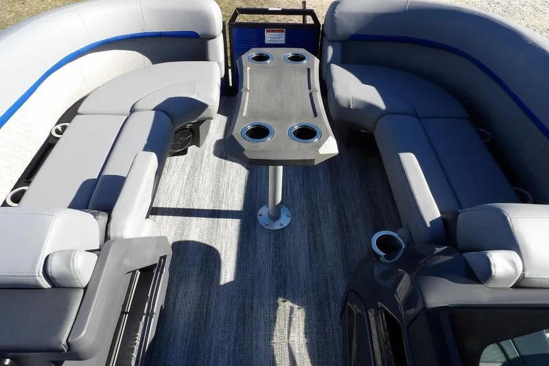 Slide: The Image of 2026 Bennington M Quad Bench 22 MFB pontoon interior with gray seating and table. - 15