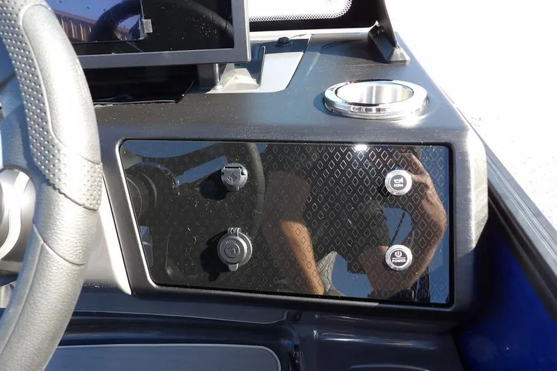 Slide: The Image of Dashboard of 2026 Bennington M Quad Bench 22 MFB with controls and cup holder. - 19