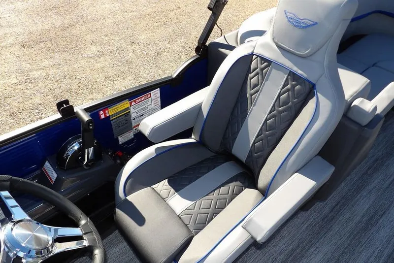 Slide: The Image of 2026 Bennington M Quad Bench 22 MFB boat interior with luxury seating and steering wheel. - 26