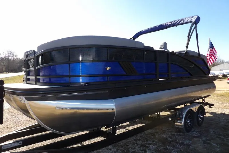 Slide: The Image of 2026 Bennington M Quad Bench 22 MFB pontoon boat on trailer, featuring sleek design and American flag. - 3