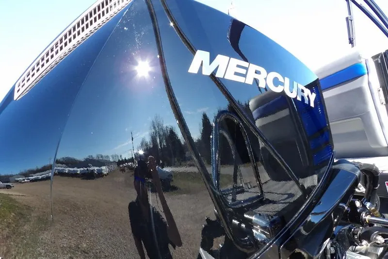 Slide: The Image of Mercury engine on 2026 Bennington M Quad Bench 22 MFB boat, reflecting sunlight. - 32