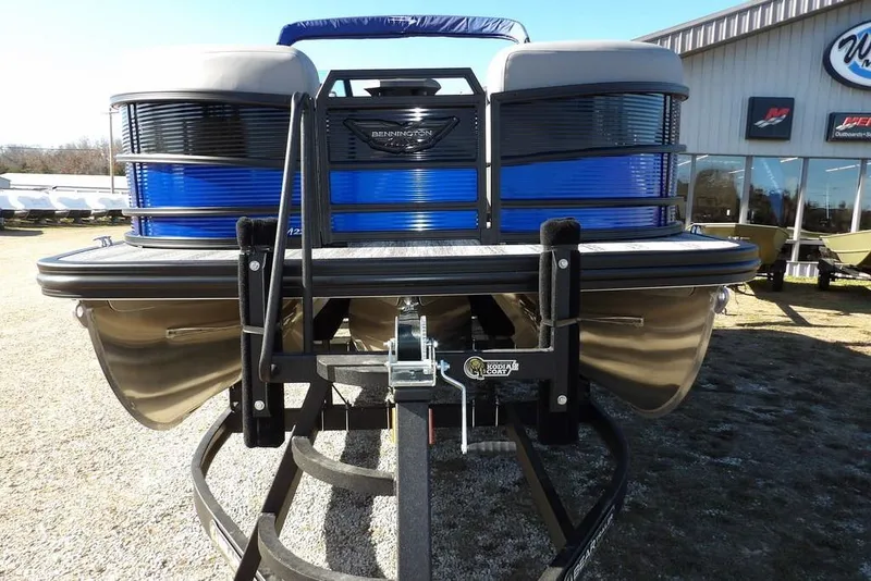 Slide: The Image of 2026 Bennington M Quad Bench 22 MFB pontoon boat on trailer, outdoor display. - 4