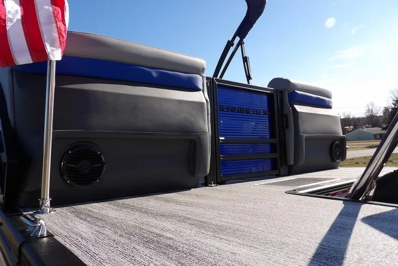 Slide: The Image of 2026 Bennington M Quad Bench 22 MFB boat interior with American flag and speaker. - 40