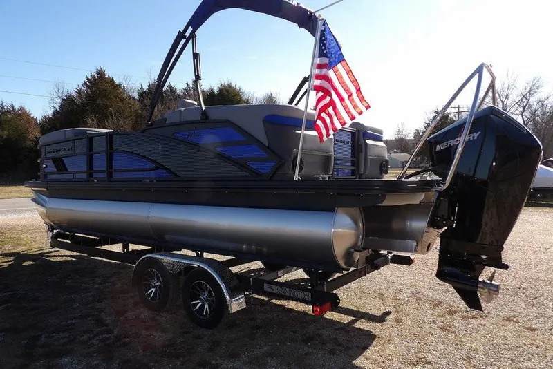 Slide: The Image of 2026 Bennington M Quad Bench 22 MFB pontoon boat with American flag and Mercury engine. - 6