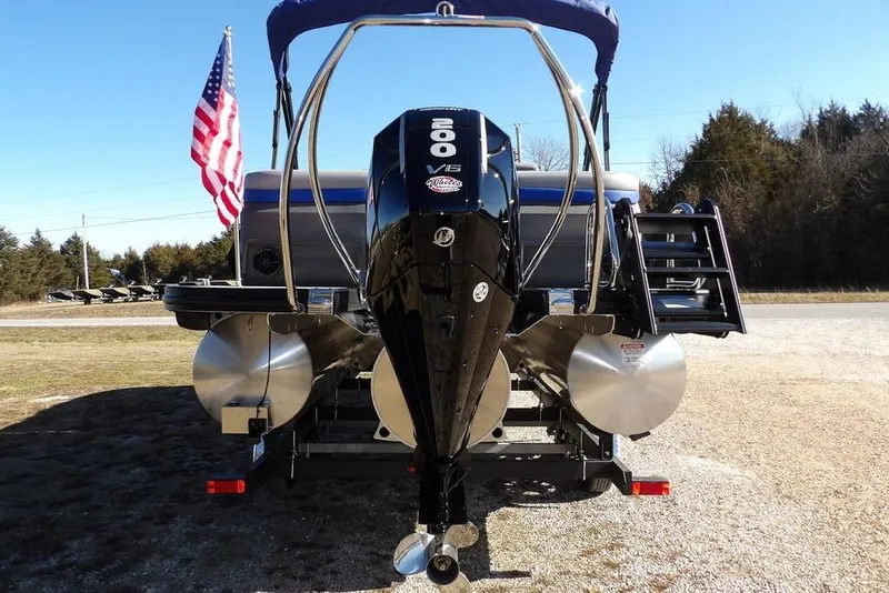 Slide: The Image of 2026 Bennington M Quad Bench 22 MFB pontoon boat with powerful V6 engine and American flag. - 7