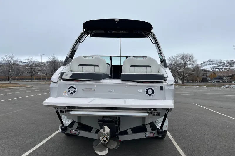 Slide: The Image of 2025 Regal LS4 boat rear view in parking lot, showcasing sleek design and modern features. - 3