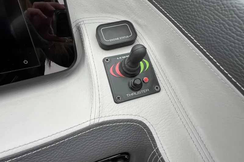 Slide: The Image of Control panel of 2025 Regal LS4 boat with thruster joystick and engine status display. - 8