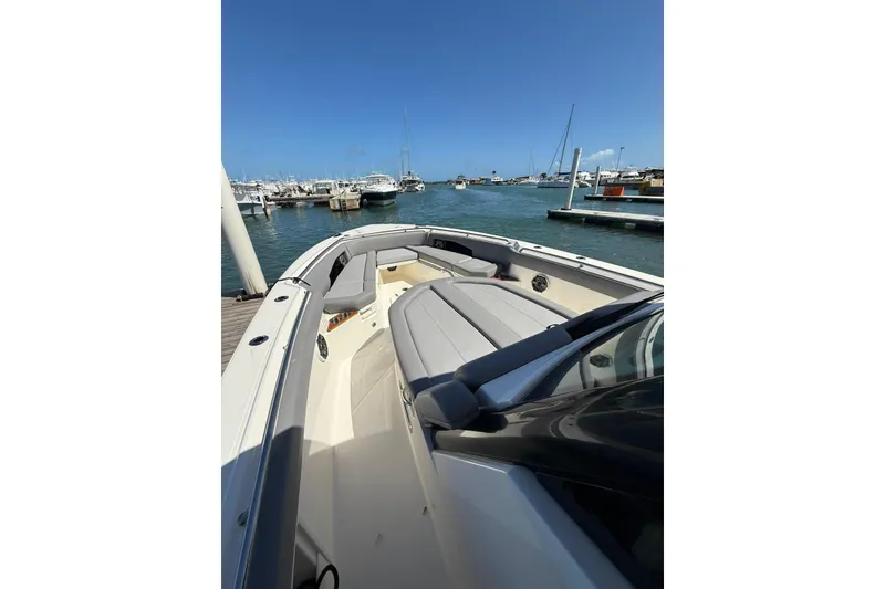 Slide: The Image of 2023 Boston Whaler 360 Outrage boat docked at marina, clear blue sky. - 3