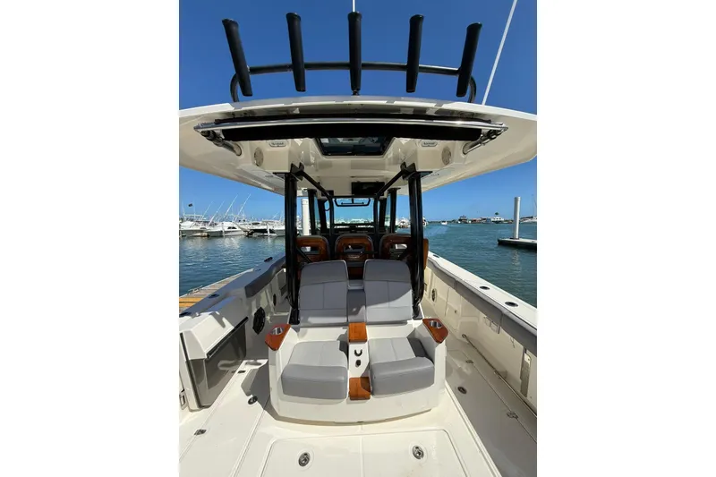 Slide: The Image of 2023 Boston Whaler 360 Outrage boat interior with seating, docked at marina. - 6