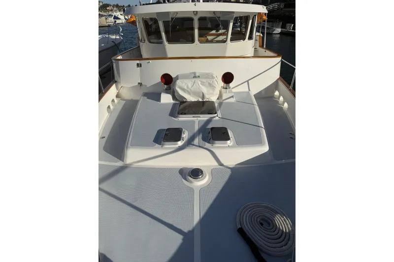 Slide: The Image of 1989 Nordhavn 46 yacht deck with coiled rope and cabin view. - 14