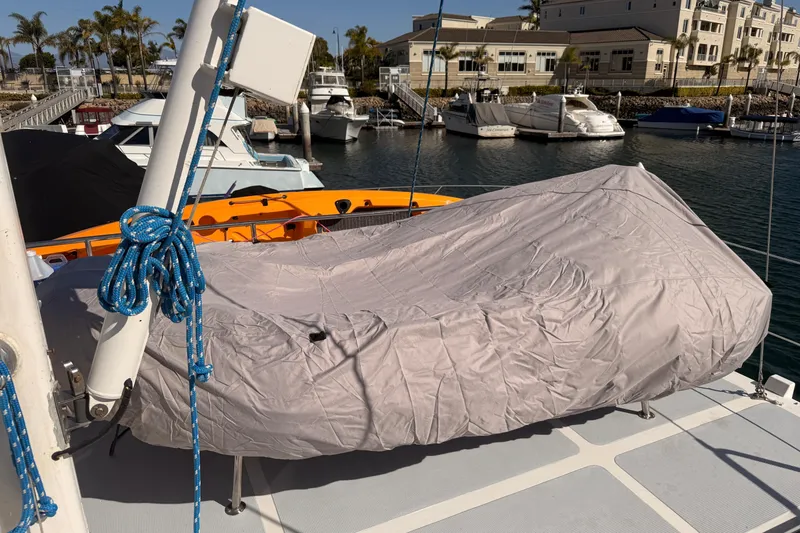 Slide: The Image of Covered boat on 1989 Nordhavn 46 deck, marina background, blue rope detail. - 16