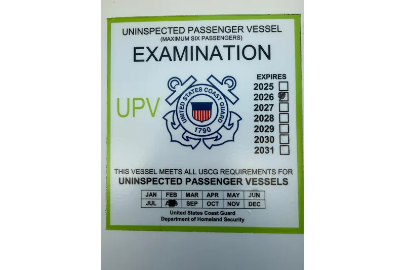 Slide: The Image of 1989 Nordhavn 46 vessel USCG examination sticker, valid until 2026, for uninspected passenger vessels. - 19