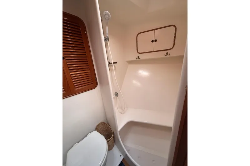 Slide: The Image of Bathroom interior of 1989 Nordhavn 46 yacht with shower and wooden accents. - 23