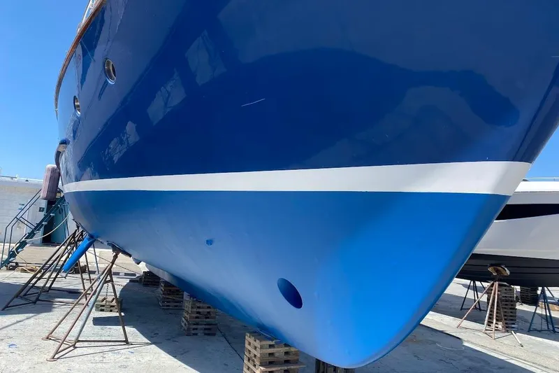 Slide: The Image of 1989 Nordhavn 46 yacht on dry dock, showcasing blue hull and white stripe. - 4