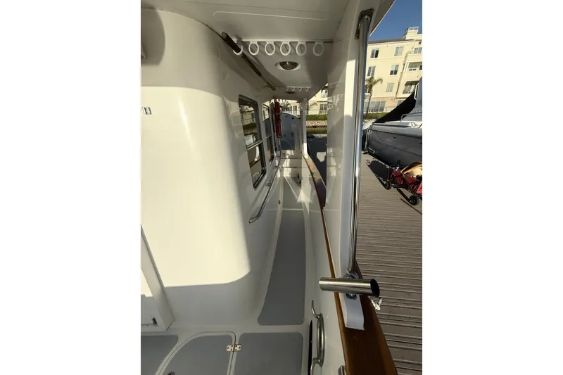 Slide: The Image of 1989 Nordhavn 46 yacht deck view, showcasing sleek design and dockside setting. - 6