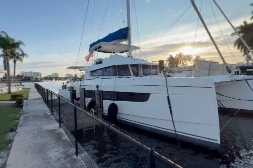 The Image of Bali 5.4 catamaran docked at sunset, 2021 model, with palm trees and waterfront view. - 1